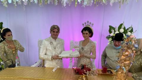 A bride and a groom in festive costumes