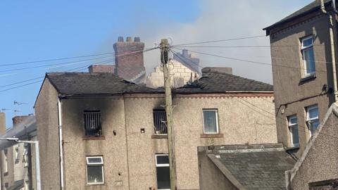 A fire-damaged roof on one of the Barrow properties