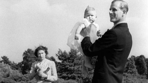 Prince Charles being lifted up by his father The Duke of Edinburgh, in the grounds of Windlesham Moor, the country home in Surrey of Princess Elizabeth and the Duke