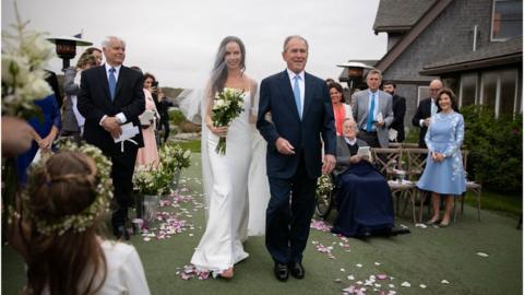 Former President George W Bush walks his daughter down the aisle
