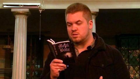 Rob Byrde reading a metal bible