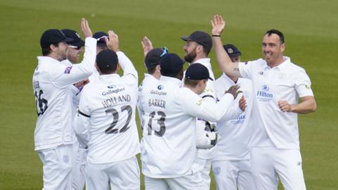 Kyle Abbott (right) celebrates a wicket with his Hampshire team mates