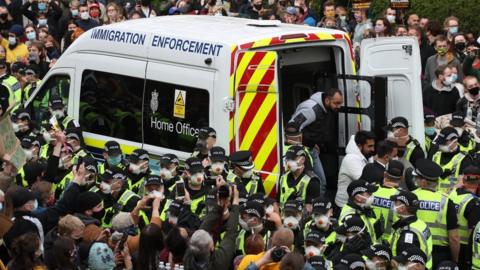 -Two men are released from the back of an Immigration Enforcement van accompanied by lawyer Aamer Anwar and Mohammad Asif, director of the Afghan Human Rights Foundation, in Kenmure Street, Glasgow