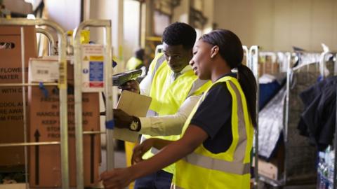 stock image of workers in a warehouse