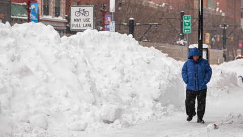 A man walks down a side walk following a winter storm in Buffalo, New York