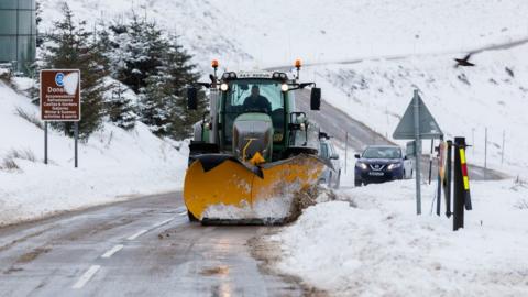 A snow plough clears the A939 after heavy snowfall in the Scottish Highlands