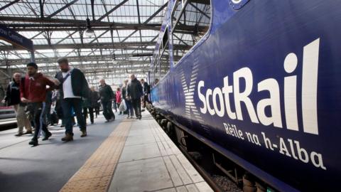 A ScotRail train is pictured in a station as commuters disembark