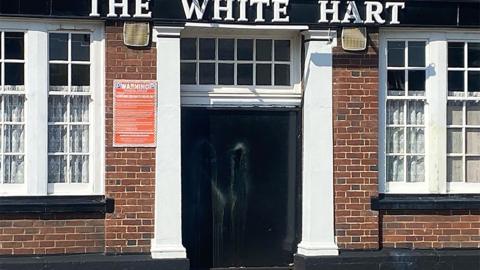 Paint smears on door of White Hart Inn