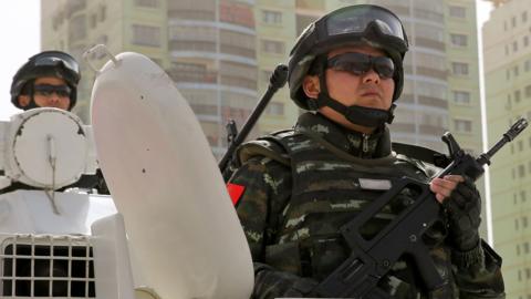 This photo taken on 27 February 2017 shows armed Chinese military police on the top of an armoured personnel carrier.