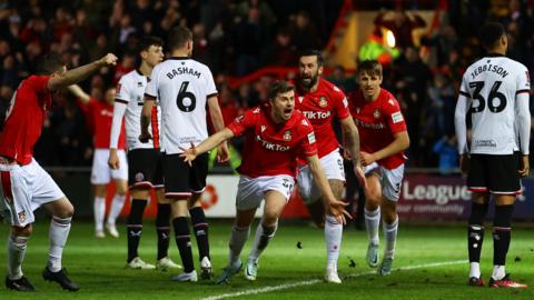 Wrexham players celebrate scoring