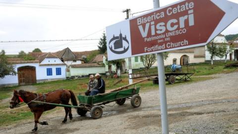 Men ride a carriage in Viscri in 2010