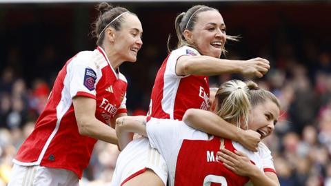 Arsenal players celebrate Alessia Russo's opening goal against Tottenham in the WSL