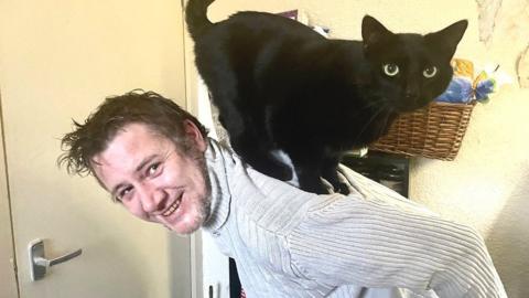 Chris Forrest with one of his cats