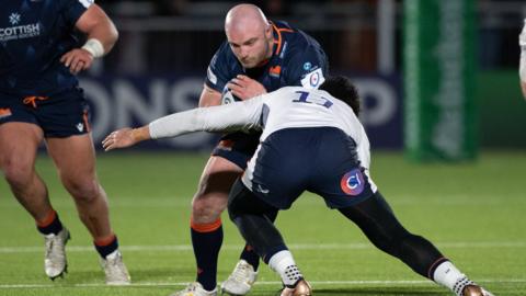 Edinburgh try scorer Dave Cherry is tackled by Sean Maitland