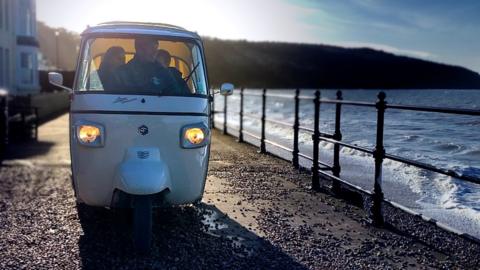 Scout driving his tuk-tuk on the Isle of Wight