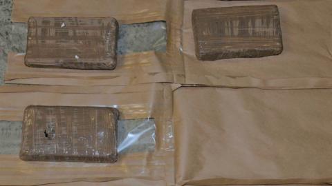 Class A drugs concealed in brown paper packaging.