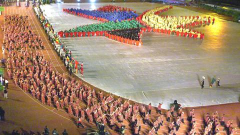 The South African team walks into the Johannesburg stadium while hundreds of children form the logo of the games, during the opening ceremony of the 7th All African Games