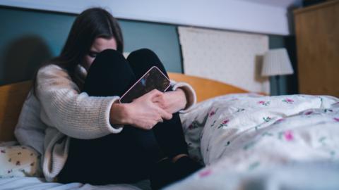 Distressed girl with mobile phone