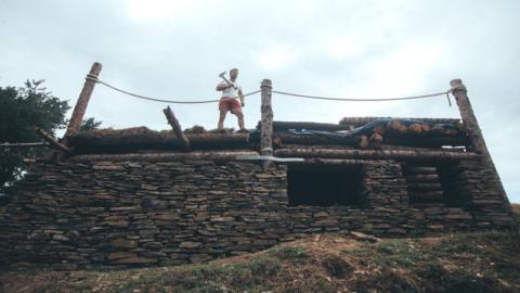 Mike Allen standing on his new cabin