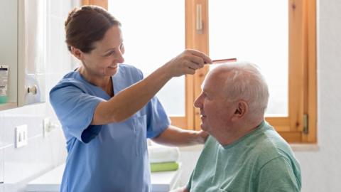 鶹Լ Caregiver with senior man in bathroom - stock photo