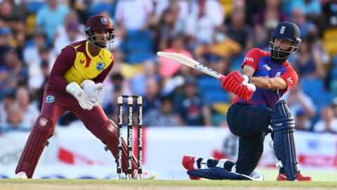 West Indies wicketkeeper Nicholas Pooran and England batter Moeen Ali