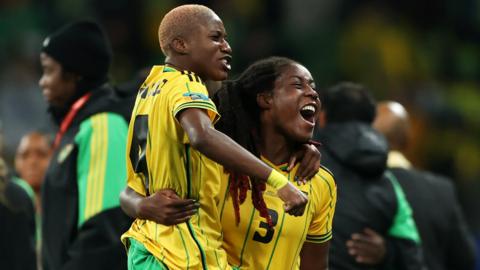 Jamaica players celebrate reaching the last-16 stage