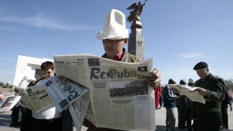 Kyrgyz residents read newspapers in the downtown of Bishkek, 30 March 2005