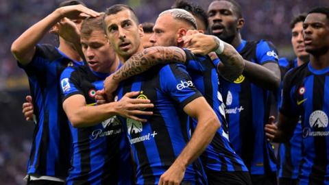 Henrikh Mkhitaryan (centre) celebrates scoring