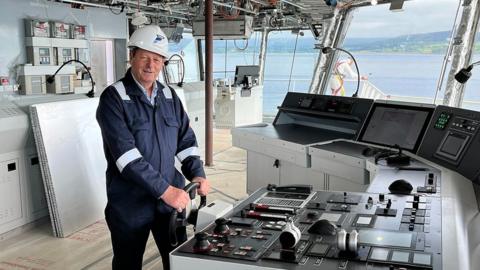 Ferguson Marine boss David Tydeman at the wheel of the Glen Sannox ship