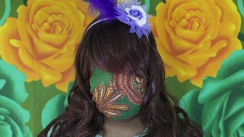 Bangladeshi woman with face covered by green fabric