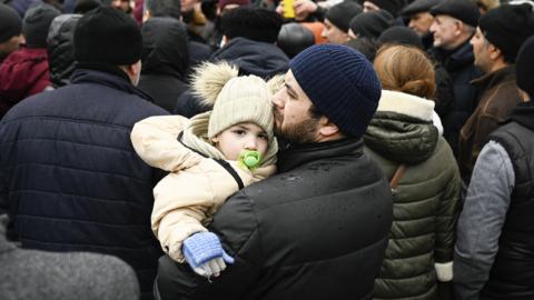 Ukrainian refugees await to enter a camp in Moldova