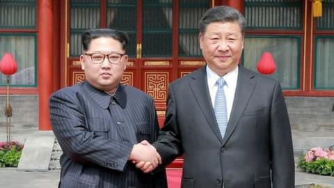 North Korean leader Kim Jong Un shakes hands with Chinese President Xi Jinping, as he paid an unofficial visit to Beijing, China,