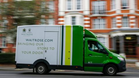A Waitrose delivery truck drives through Maida Vale, London