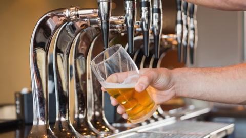 A man pulling pint of beer