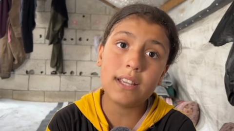 Alma speaks to the BBC at her tent in Rafah, in the southern Gaza Strip