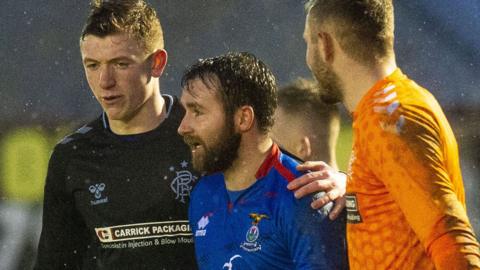 Inverness Caledonian Thistle striker James Keatings (centre) leaves the field