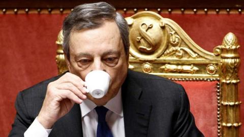 Italian Prime Minister Mario Draghi drinks coffee during his address to the Senate ahead of a confidence vote on 20 July