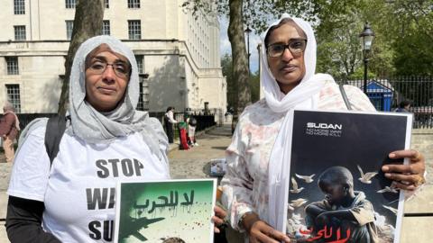 Two protestors against Sudan.