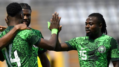 Nigeria players celebrate after scoring a goal during a match against Saudi Arabia