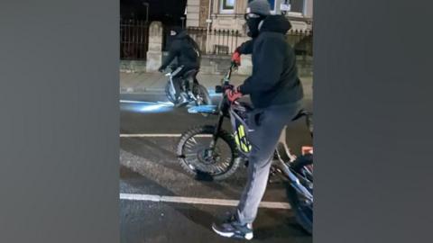 Two people on motorbikes