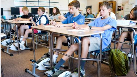 Pupils with bike pedals under their desks