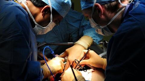 Doctors performing heart surgery