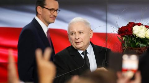 Poland's ruling party Law and Justice leader Jaroslaw Kaczynski and Polish Prime Minister Mateusz Marowiecki are seen after the exit poll results are announced in Warsaw, October 13, 2019