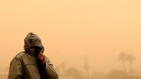 A man covers his face during a sandstorm in Cairo, Egypt, 16 January 2019