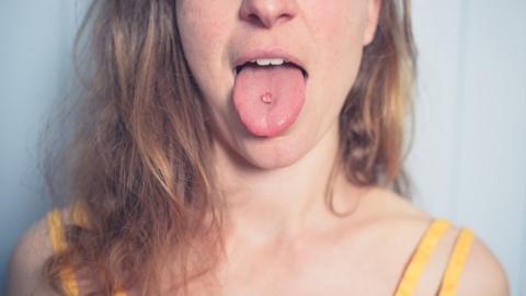 A woman with a pierced tongue