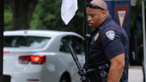 A Baton Rouge Police officer stands guard outside Our Lady of the Lake Regional Medical Center in Baton Rouge, Louisiana, USA, 17 July 2016.