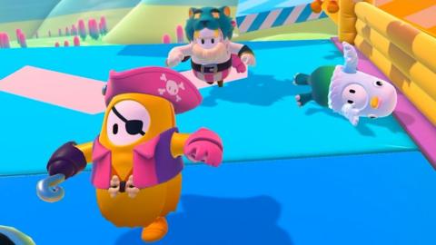 Jellybean-like figures with arms and legs leap through an obstacle course wearing a variety of silly costumes