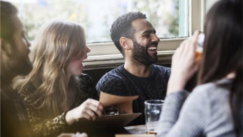 Friends enjoying a drink in a pub