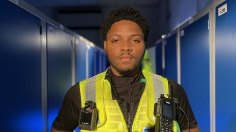 Police officer next to lockers