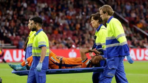 Nathan Ake is taken off on a stretcher during the Netherlands draw with Germany